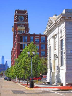 National Bank of Camden, formerly the State Bank of Camden (Market Street). Saved from demolition in the 1990s, it is now on the National Register of Historic Places. Towering nearby is the RCA Victor building, former home of the Victor Talking Machine Company. In the distance is the Philadelphia skyline.