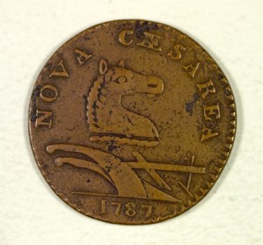 New Jersey's first state coin (first minted in 1786) [Numismatics Collection]. Taken from Pierre Eugene du Simitiere's state seal design, the horse and the plow were obvious image choices for this 1/15 shilling copper piece. The coin was the first to formally adopt the national motto "E Pluribus Unum" (one from many), which still appears on all U.S. coins. (Left: Obverse, Right: Reverse)
