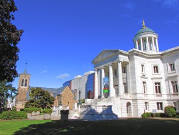 2013: Somerset County Courthouse block fronting Main Street, between today's North Bridge Street and Grove Street (Somerville). The current white marble edifice was completed in 1909. Visible in the background, the old Dutch Reformed Church building has become part of the court's administrative complex.